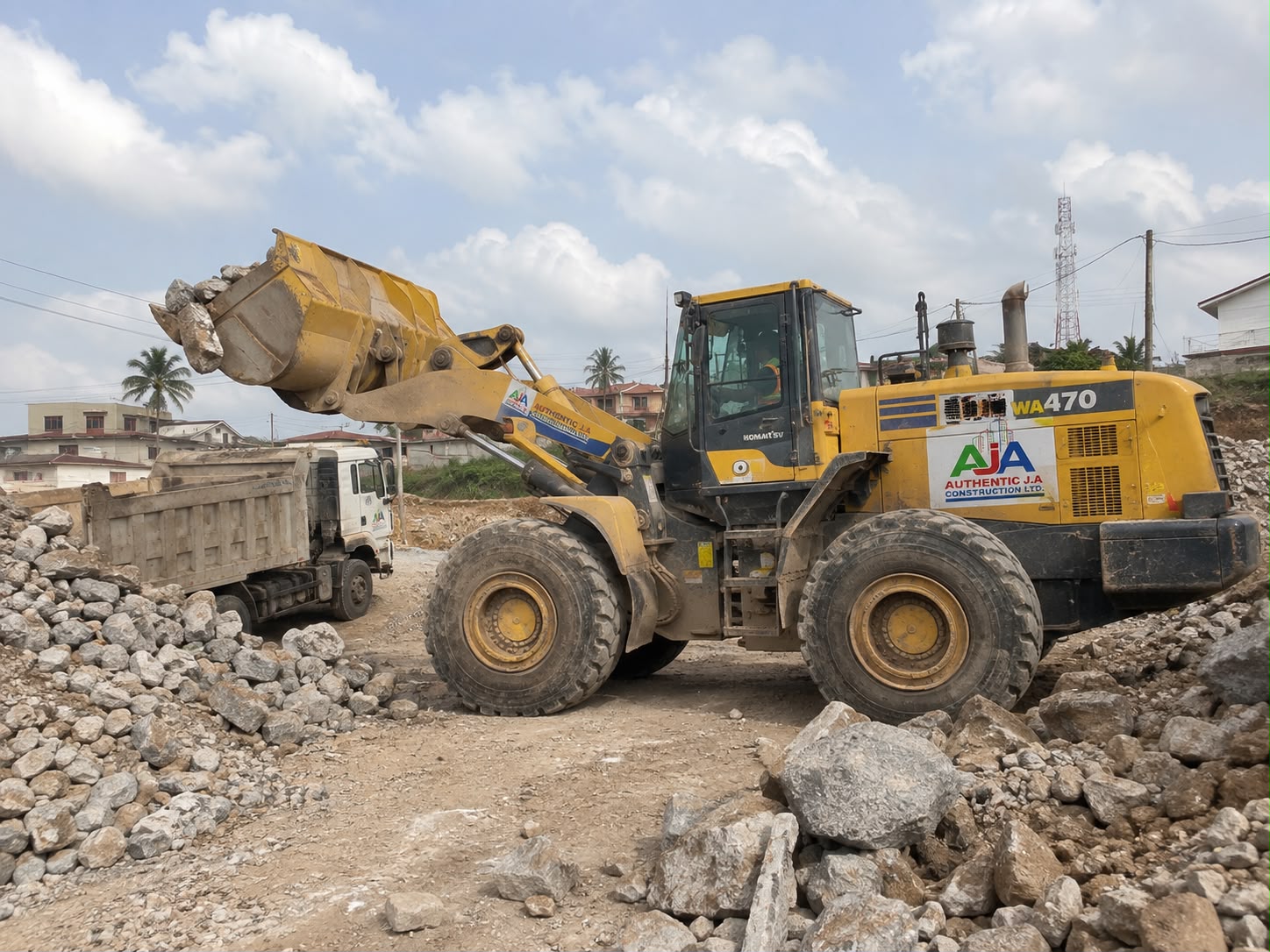 Wheel loader loading quarry stones into a tipper truck